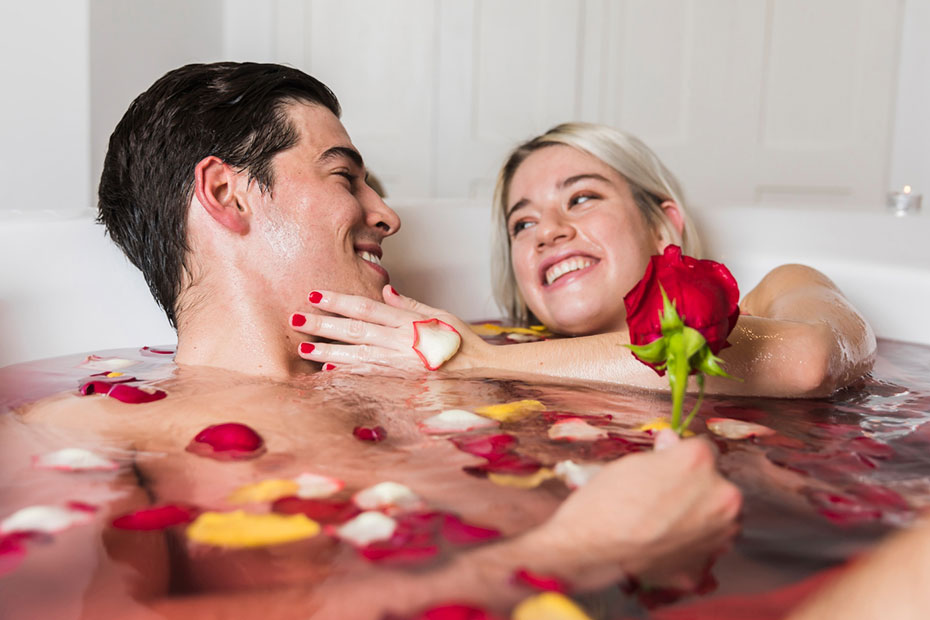 man and women having sensual massage in bath tub